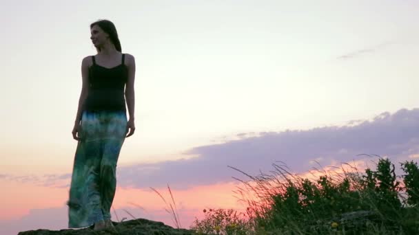 Mujer joven de pie sobre la roca. Cielo nocturno . — Vídeos de Stock