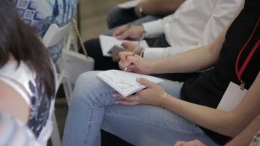 Kadın bilezik ile closeup bir kalem bir defterde yazıyor.