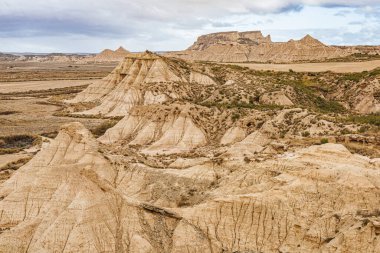 Panoramic view of the Bardenas Reales natural park in Navarra, Spain, a semi-desert landscape with eroded hills, clay formations, and unique shapes created by wind and water.