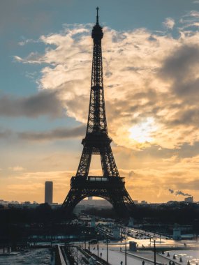 Winter view of the Eiffel Tower in Paris, France, captured during the colder season with a soft, atmospheric light.
