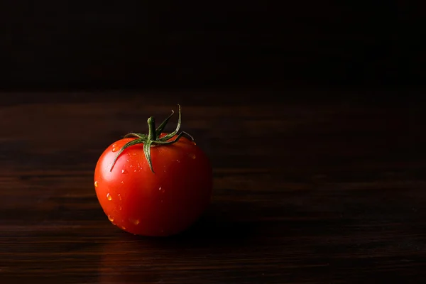 Tomato on a dark background — Stock Photo, Image