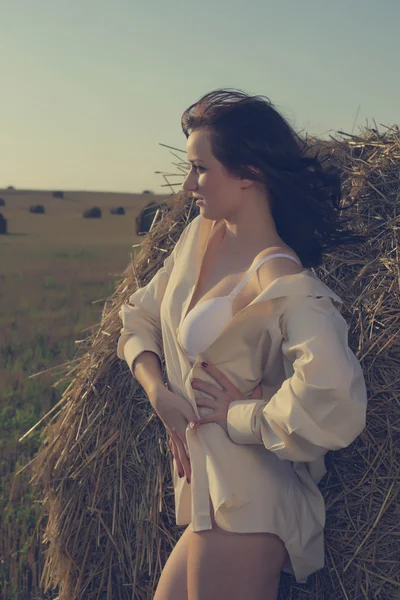 Sensual girl near a stack of a hay portrait — Stock Photo, Image