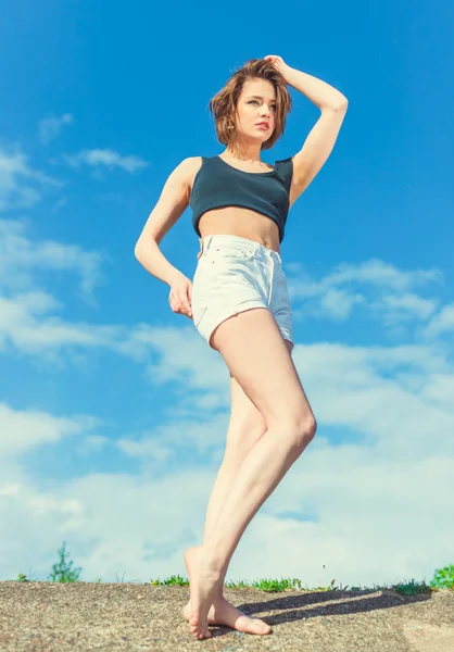 Beautiful sensual girl near water on the background of the blue sky — Stock Photo, Image