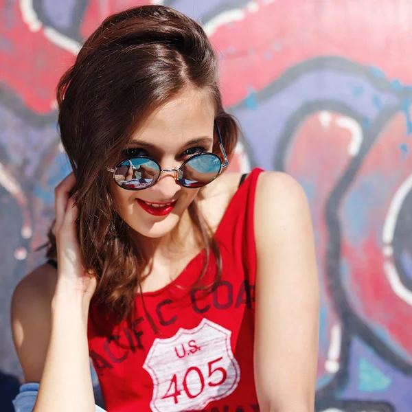 Hipster meisje in de jeans en zonnebril buiten portret — Stockfoto