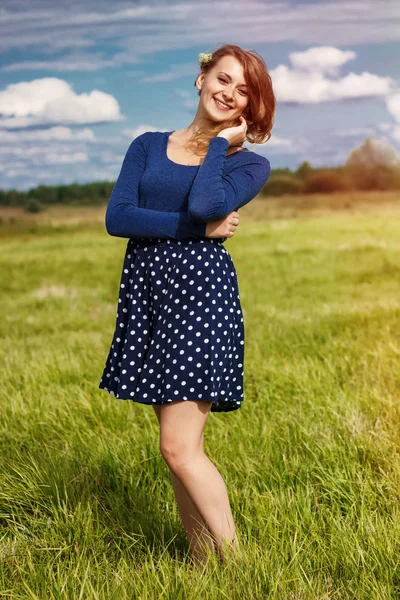 Mavi elbiseli şık hipster kızla tarlada çiçekler — Stok fotoğraf