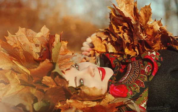 Schönes Mädchen im Herbst mit Blättern — Stockfoto