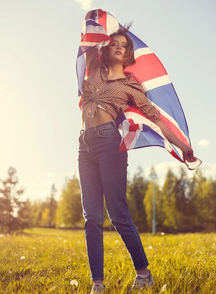 Stylish girl with the flag in the denim outdoor portrait Royalty Free Stock Images