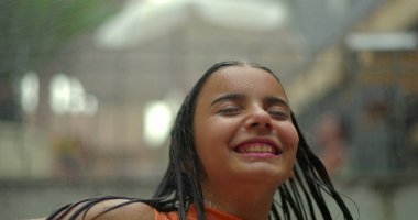 Suyun altında neşeli anların tadını çıkaran çocuk, dinamik bir şekilde hareket eden saçlar, canlı enerjiyi yakalayan, kaygısız neşe ve serinletici yaz eğlencesi.