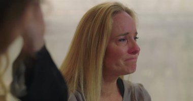 Grup terapisi sırasında duygu yüklü ağlayan kadın empati, iyileşme ve destek alanlarında acı ve hassasiyetini ifade ediyor.