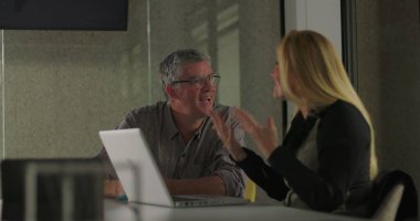 İş arkadaşları gülümser ve ofis toplantısında dostça destek anlarında el ele tutuşur, takım çalışmasını kutlar ve başarıyı paylaşırlar. 