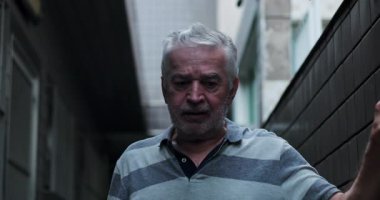 Yaşlı adam, dayanıklılığını, savunmasızlığını, azmini ve zorlu yaşam koşullarına dayanma çabasını ifade ederek gözle görülür zorluklarla ilerler.