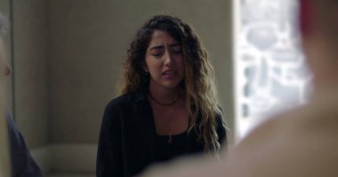 Duygusal duygularını ifade eden genç bir kadın grup terapisinde etrafını saran empatik grup üyelerinin desteğini alarak kişisel travmasını paylaşıyor.