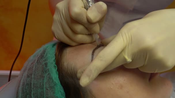 Esteticista fazendo sobrancelha de maquiagem permanente — Vídeo de Stock