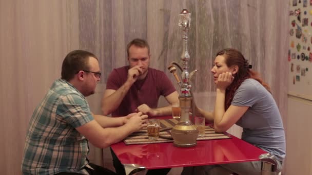 A group of people smoking shisha and playing cards — Stock Video