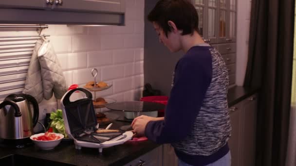 十几岁男孩烹饪煎面包 — 图库视频影像