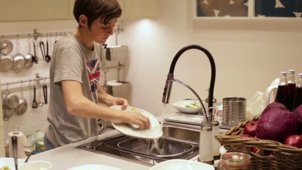 Teenager Boy Washing Dishes in the Sink — Stock Video