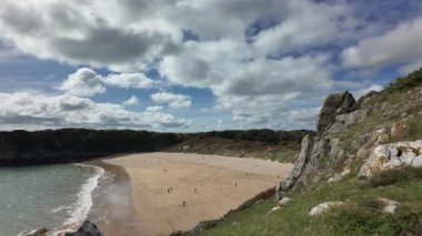 Timelapse of Barafundle Bay Beach on the Pembrokeshire coast, Wales on a bright summers day with a calm sea.