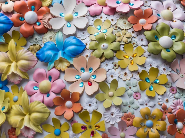 Fantasy plastic flowers on wall — Stock Photo, Image