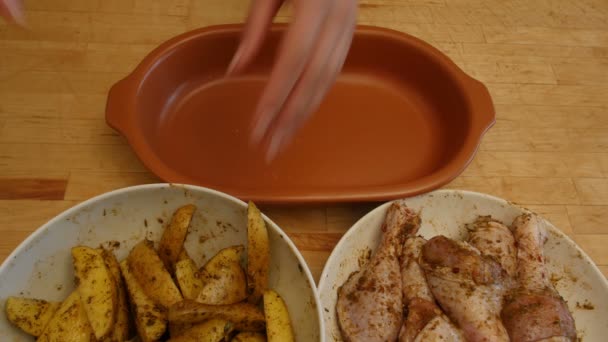 Una donna prepara un pollo con patate in forno. 4k — Video Stock