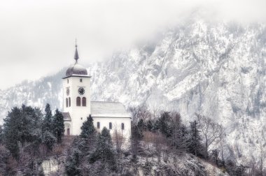 Cristian church on a snow covered hill in winter near Salzburg, Austria