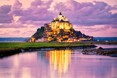 Mont Saint-Michel reflecting in water on sunset, Normandy, France clipart