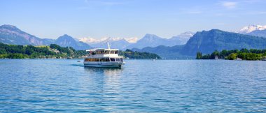 Cruise ship in front of Alps mountains peaks on Lake Lucerne, Switerland