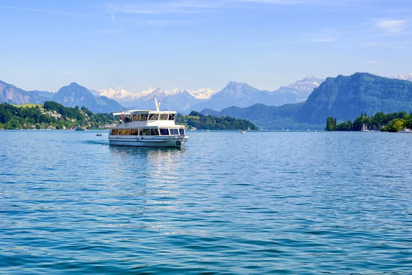 Cruise ship in front of Alps mountains peaks on Lake Lucerne, Switerland