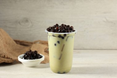 Matcha Bubble Tea with Tapioca Pearls in OPlastic To Go Glass, Copy Space for Text 