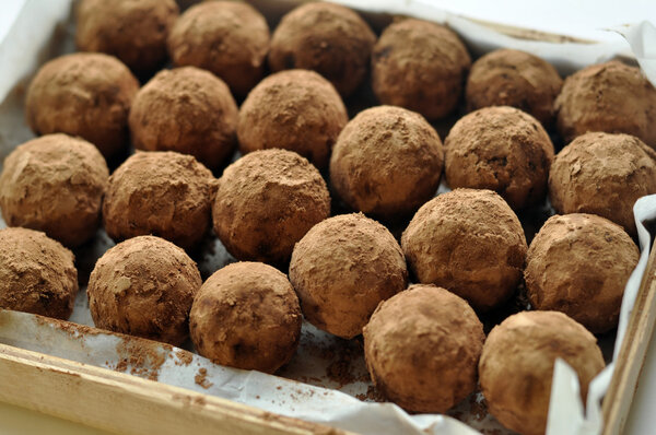 A wooden box with homemade round chocolate candies