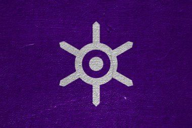 The official flag of Tokyo, the capital of Japan, on a cracked wall texture. Conceptual collage.