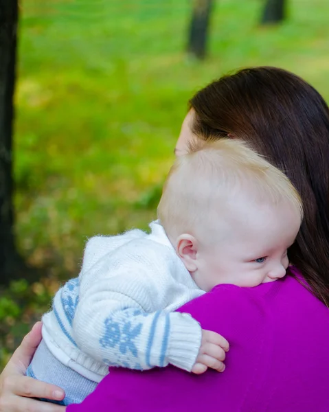 Mother hugs her baby in the park Royalty Free Stock Images