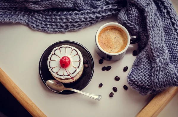 Sweet cake with a cherry and cup of coffee — Stock Photo, Image