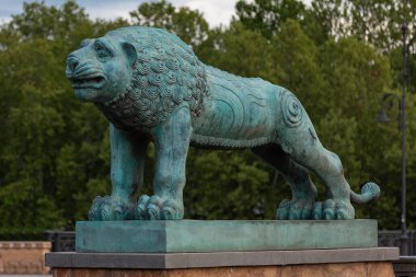 Lion on the G. Tabidze bridge in the city of Tbilisi. Georgia. Statue of bronze green from time