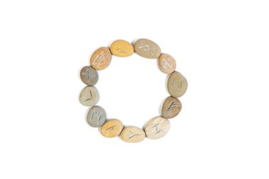 Rune Stones Arranged in Circle on White Background