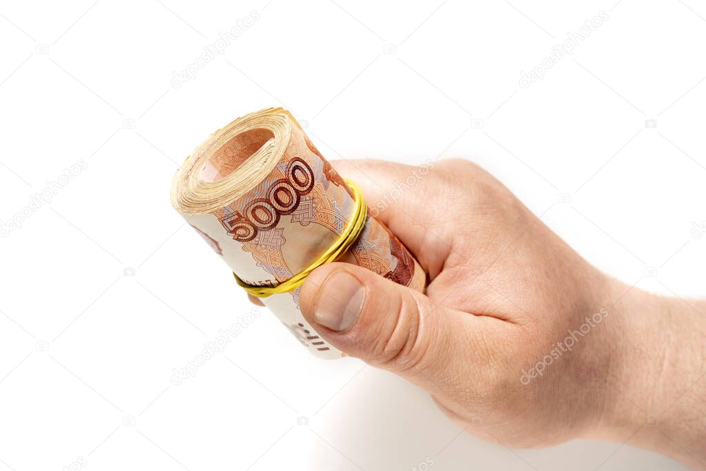 A roll of banknotes of 5000 Russian rubles. Transfer of money. Bribery.