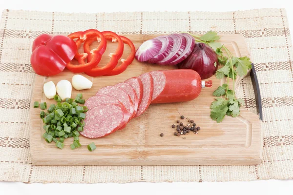 Sliced sausages on chopping board — Stock Photo, Image