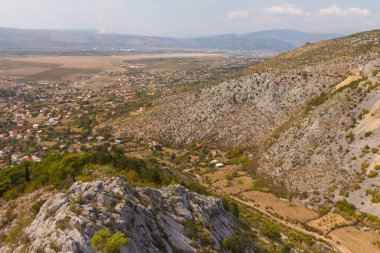 Güneşli bir günde Blagaj kasabasındaki dağın tepesinden manzarayı izleyin. Bosna-Hersek