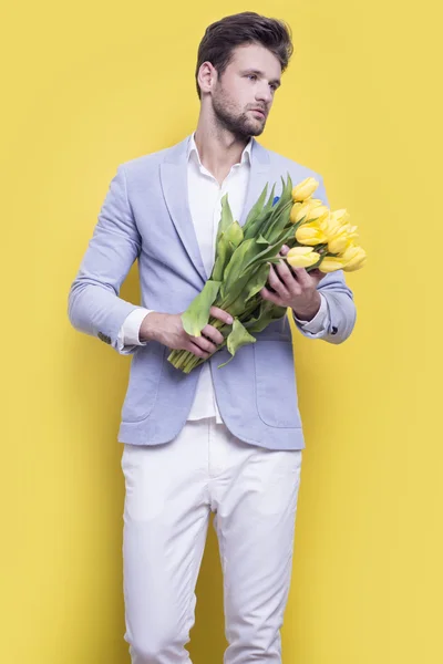 Man holding yellow tulips — Stock Photo, Image