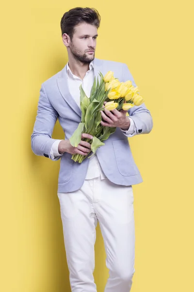 Man holding yellow tulips — Stock Photo, Image