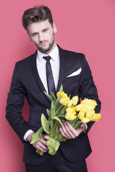 Man holding yellow tulips 