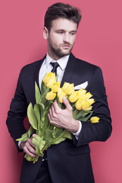 Man holding yellow tulips 