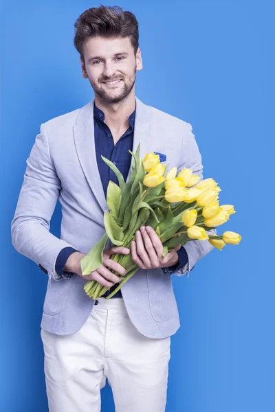 Man holding yellow tulips — Stock Photo, Image