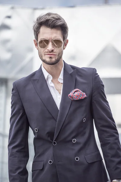 Handsome man in the jacket on a city background — Stock Photo, Image