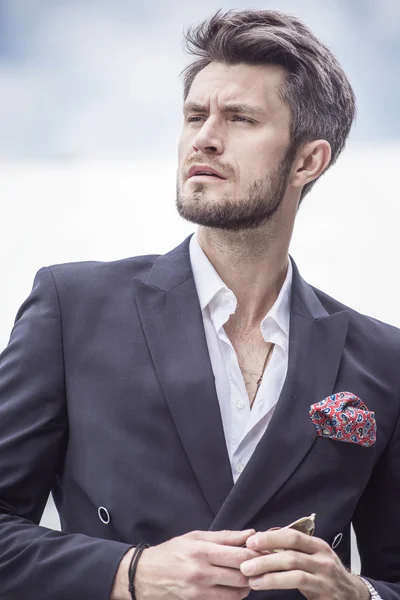 Handsome man in the jacket on a city background — Stock Photo, Image