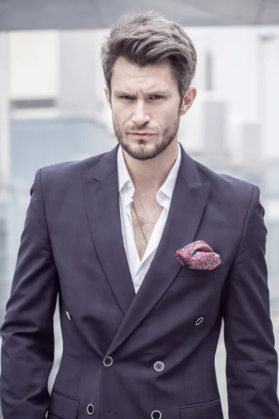 Portrait of a man in the jacket on a city background — Stock Photo, Image