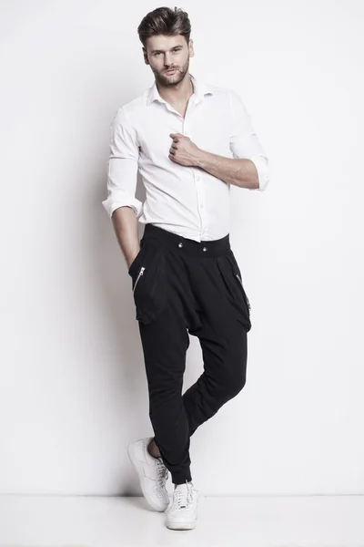 Handsome man in shirt and sports pants — Stock Photo, Image