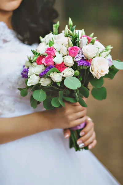 Noiva está segurando lindo buquê de casamento brilhante — Fotografia de Stock