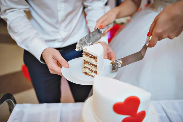 Bride and Groom at Wedding Reception Cutting the Wedding Cake with hearts — Stock Photo, Image