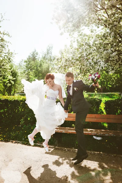 Wedding couple having fun and jumping together