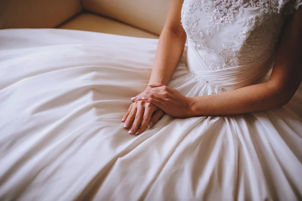 Hermosas manos de la novia en el vestido de encaje blanco de la boda — Foto de Stock